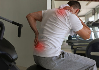 Man with Back Pain in Gym. Sports exercising injury