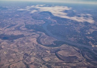 Mississippi River aerial landscape views from airplane over the border of Arkansas and Mississippi. Winding river and Rural town and cities, United States of America. USA.