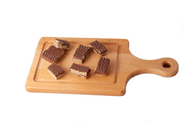 chocolate wrafer biscut on wooden cutting board with knife
