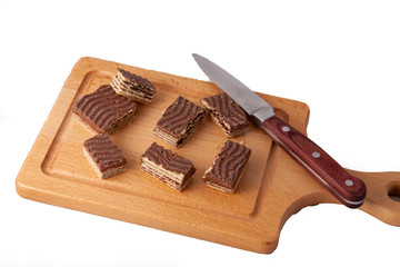 chocolate wrafer biscut on wooden cutting board with knife