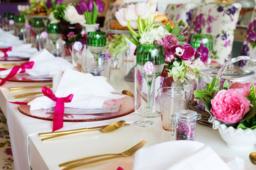 Dinning table colorfully decorated with flowers and fruits