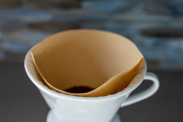 making pour over coffee with a stainless steel kettle on a gas stove