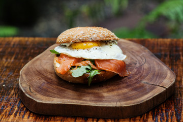 Salmon egg hamburger displayed on a beautiful wooden plate