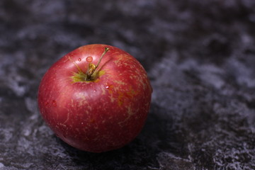 red apple on a black background