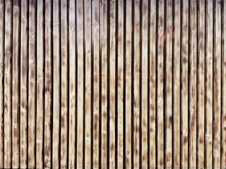 Wooden thin slats with traces of firing. Thin vertical slats.Wooden background.