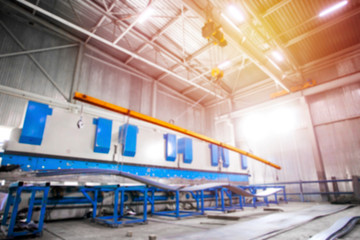 Yellow Factory overhead crane carries cargo at the plant. Cargo moving. Blurred. Out of focus. Concept.