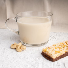 Healthy breakfast. Organic milk. Cereal granola bar. Glass cup with organic milk. Nut milk without lactose, gmo, antibiotics and casein. Diet food.  ..