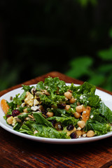 Healthy green kale salad with chickpeas, feta cheese, nuts