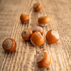 Close up of inshell hazelnuts. Nuts mix on the old rustic wooden background. Food for man's and women health. Raw foods for vegetarians and vegans.