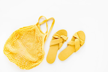 Yellow slippers with eco bag. Flat lay, top view. Summer Vacation concept.