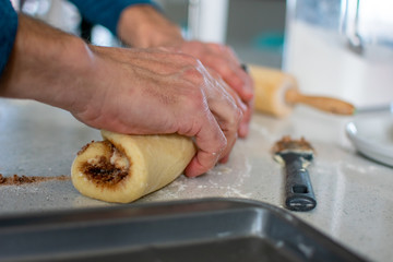 Rolling cinnamon roll dough