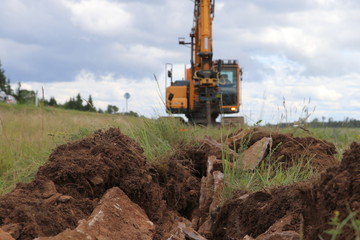 Crawler Excavator Works on digging the Trench for a cable 