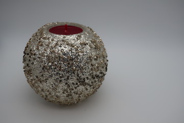 Red candle in a silver candle stand 