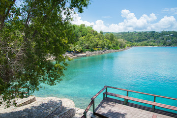James Bond Beach, Jamaica. A view of the bay, with turquoise waters and green trees in the background