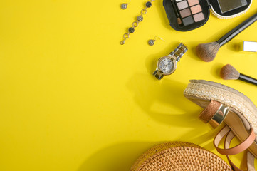 Blogging Beauty Concept. Professional female makeup accessories, watches, bracelet, shadow bag on a yellow background. Female background and fashion. Instagram, women's stuff. Flat lay