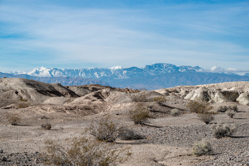 USA, Nevada, Clark County, Tule Springs Fossil Beds National Monument: White gypsum hills with Mt. Charleston in the distance.