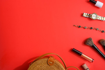 Blogging Beauty Concept. Professional female makeup accessories, watches, bracelet, bag on a red background. Female background and fashion. Instagram, women's stuff. Flat Layout Creative Light