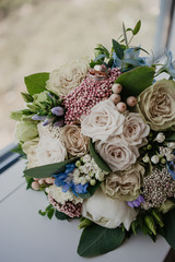 2 golden rings on wedding bouquet with beautiful roses. Wedding day. Wedding preparation