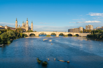Puente de Piedra bridge across the river Ebro and the ancient church Basilica del Pillar in the Spanish city Zaragoza