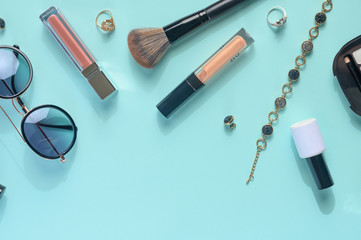Blogging Beauty Concept. Professional female makeup accessories, watches, bracelet, glasses on a blue background. Female background and fashion. Instagram, women's stuff. Flat lay banner