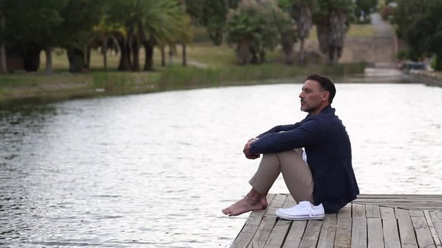 Hombre relajado frente a un lago 
