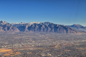 Wasatch Front Rocky Mountain Range Aerial view from airplane in fall including urban cities and the Great Salt Lake around Salt Lake City, Utah, United States of America. USA.