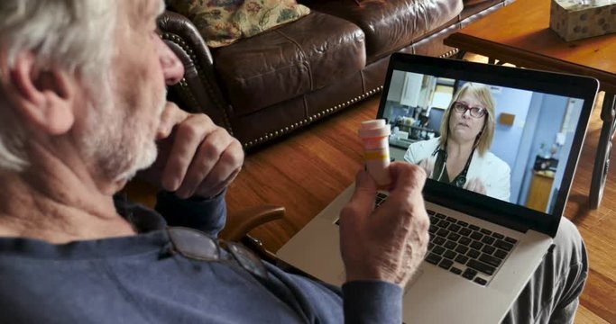 Elderly man talking to a doctor via telemedicine about his medication