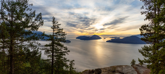 Tunnel Bluffs Hike, in Howe Sound, North of Vancouver, British Columbia, Canada. Panoramic Canadian Mountain Landscape View from the Peak during sunny winter sunset.