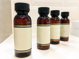 Beauty product plastic bottles on the granite shelf