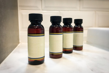 Beauty product plastic bottles on the granite shelf