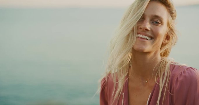 Portrait of attractive woman smiling at sunset