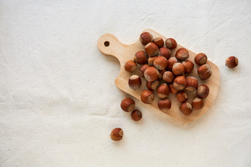 Hazelnuts on a light fabric background