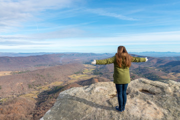 Young woman on the observation point on McAfee Knob