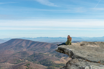 Young woman on the observation point on McAfee Knob