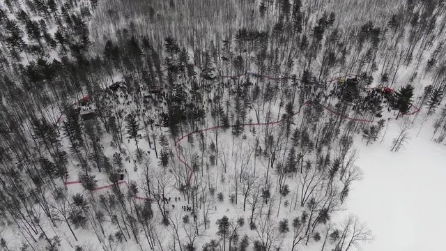 Winter party in the woods in Traverse City Michigan 4K drone shots over forest and open woods in winter snow covered scene cold air