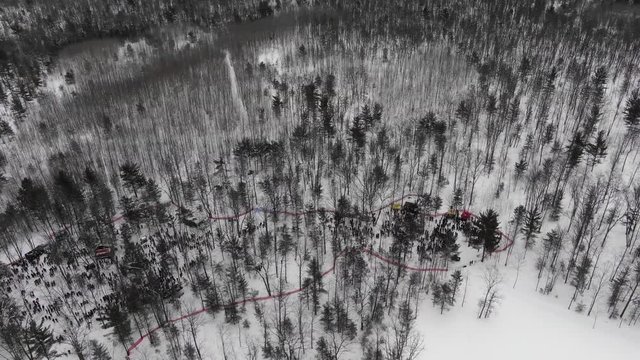 Winter party in the woods in Traverse City Michigan 4K drone shots over forest and open woods in winter snow covered scene