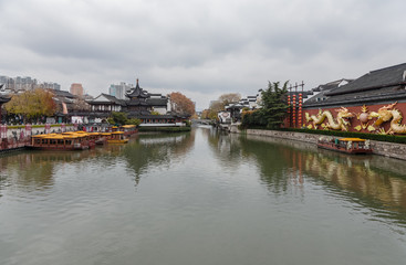 Obraz premium Qinhuai River and Fuzimiao from Wende Bridge, Nanjing, Jiangsu, China, with Kuaiguan Pavilion on left bank and Great Spirit Screen on right decorated with dragons, Nanjing, Jiangsu, China