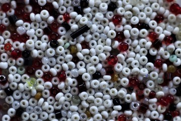 Round beads of white, red black colors.