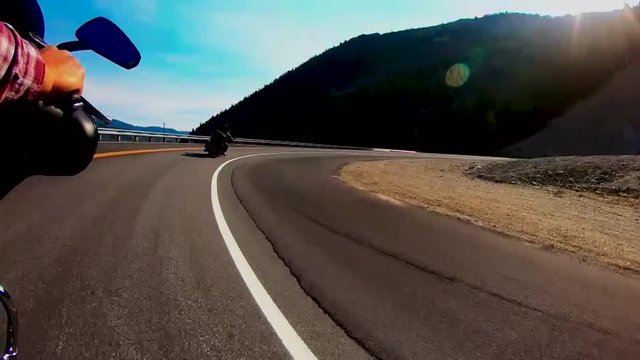 Riding thru a sweeping Mountain road corner on a Harley