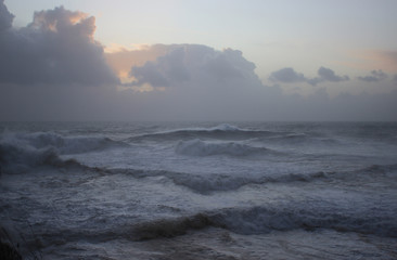 Waves in Nazare with a cloudy sunny sky