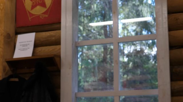 Tilt down of fragment of room in former soviet union, the USSR komsomol room, selective focus on hanging kerosene lamp.