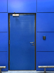 Blue door with modern yellow wall