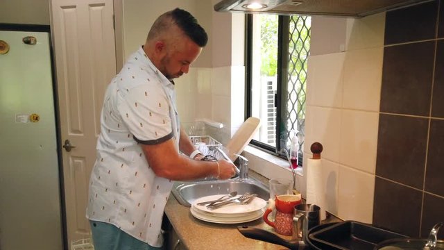 great husband doing dishes, washing potato masher, dirty dishes, doing the dishes, cleaning the kitchen, kitchen sink ,