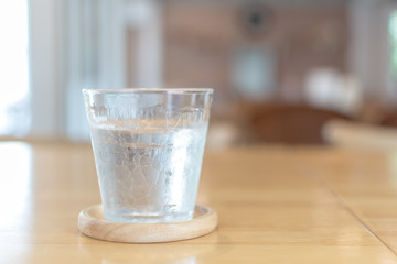 Some glass of water on the wooden table in restaurant.Selective focus.