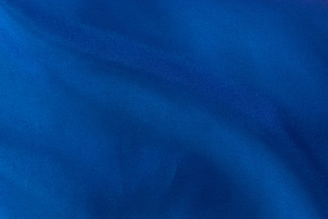 Luxury deep blue fabric background.Smooth pattern.Silk velvet material texture.Using for backdrop or wallpaper.Dark tone color.Soft focus.
