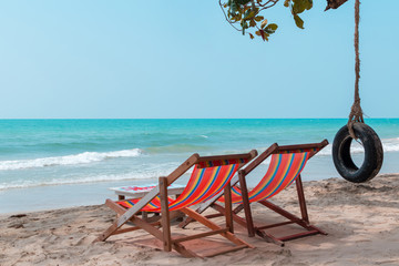 Couple beach chairs and swing with blue sky cloudless background at hawaii beach.