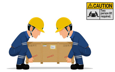 Two workers is lifting the heavy wooden crate