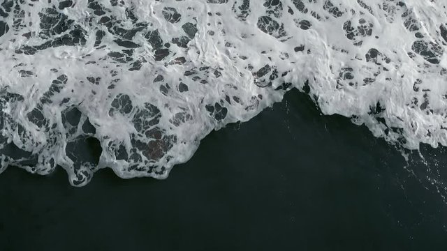 Big Waves rolling from above. Top down close-up 4K drone view on blue ocean, breaking waves, whitewash. Sunny morning over the sea. Bali island, Indonesia. ProRes