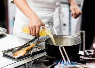Chef cooking, Chef preparing food in the kitchen, Chef decorating dish, closeup.