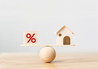 Interest rate financial and mortgage rates concept. Wooden home and cube block shape with icon...